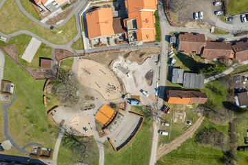 Aerial view on a playground in European town, village in Sweden. Reconstruction of сhildren's playground near a residential apartment complex. Recreational area, urbanism.