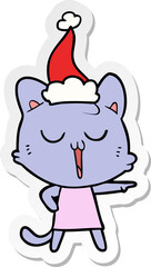 sticker cartoon of a cat singing wearing santa hat