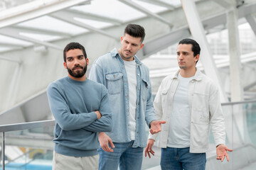 Three Male Friends Having Quarrel Traveling Together Standing In Airport