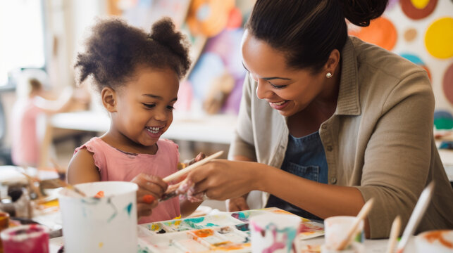 A mother and her child participating in a creative, art-focused activity together, such as painting or pottery, as a special Mother's Day bonding experience