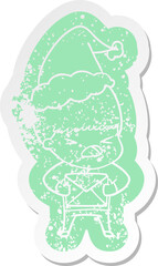 cartoon distressed sticker of a stressed man wearing santa hat