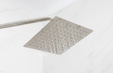 Large modern shower head from which water flows in the shower. shower set, close-up.