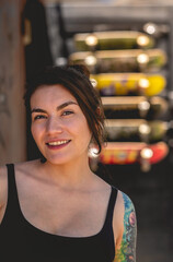 Sexy urban style: portrait of rebel young woman with little black top and shorts, tattoos and...