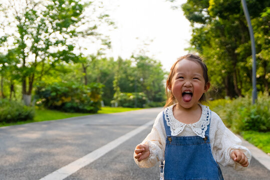happy asian kid in the park early summer