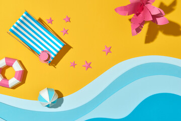 Obraz premium Top view of mini beach deck chair, ring float, ball and starfishs