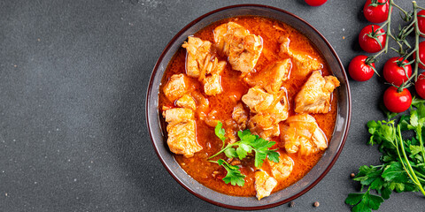 chicken meat tomato sauce, vegetable meal food snack on the table copy space food background rustic...