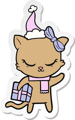 cute sticker cartoon of a cat with present wearing santa hat