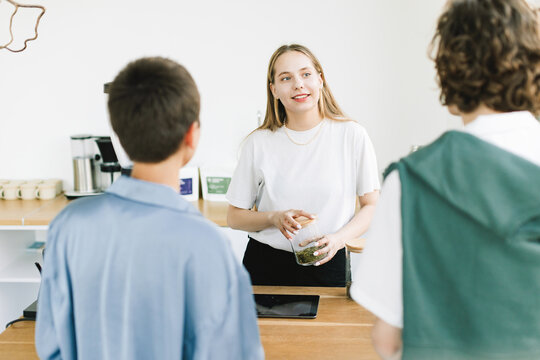 Clients Meet Blonde Female Administrator at Her Desk