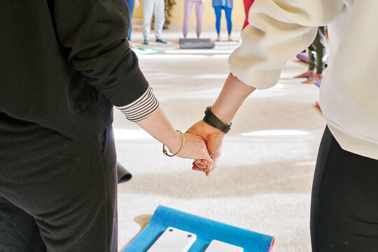 Two people holding hands