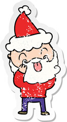 man with beard sticking out tongue wearing santa hat