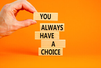 You always have choice symbol. Concept words You always have a choice on wooden block. Beautiful orange table orange background. Businessman hand. Business you always have choice concept. Copy space.