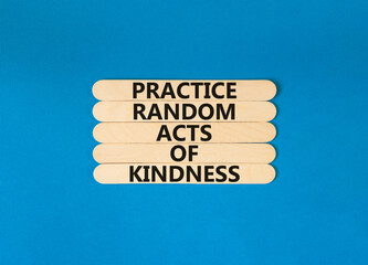 Practice random kind of kindness symbol. Concept words Practice random kind of kindness on wooden stick. Beautiful blue table blue background. Business practice kindness concept. Copy space.