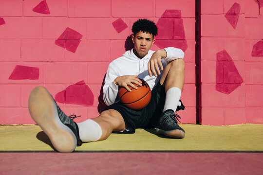 Basketball player sitting on a court's floor
