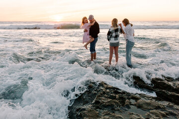 Happy Family with teenagers on the beach together