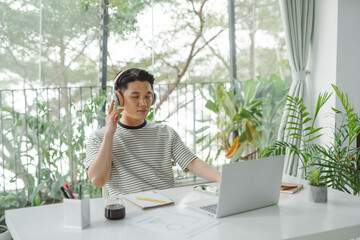 Relaxed man businessman freelancer listening to the music