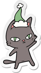 sticker cartoon of a cat staring wearing santa hat
