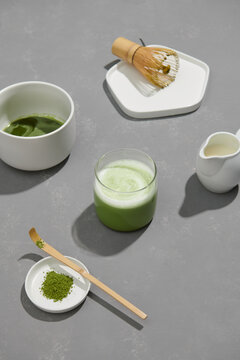 Matcha green tea latte in a cup with cream