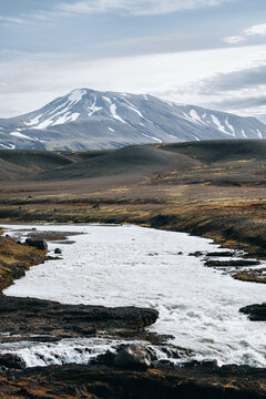 North landscape: waterfall with glacier river, volcanic snowy mountain
