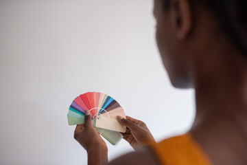 Black designer choosing color from palette