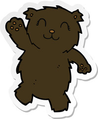 sticker of a cartoon waving black bear
