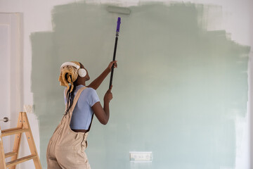 Female painter listening to music and dancing