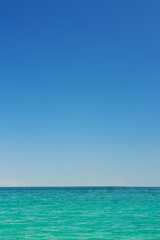 Fototapeta na wymiar Beautiful idyllic seascape with blue sky. Clear sky and calm sea or ocean water surface background