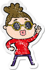 distressed sticker of a cartoon waving woman wearing sunglasses