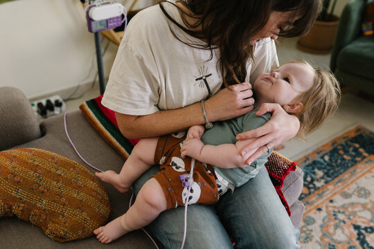 Mother with a baby who needs food through the tube