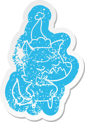 friendly cartoon distressed sticker of a fox wearing santa hat