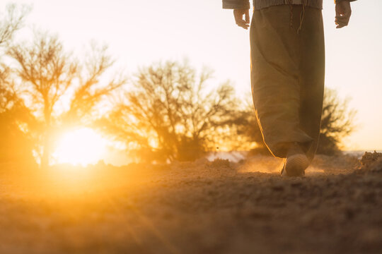 Man walking towards sunset