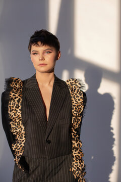Androgynous model in formal wear with playful details