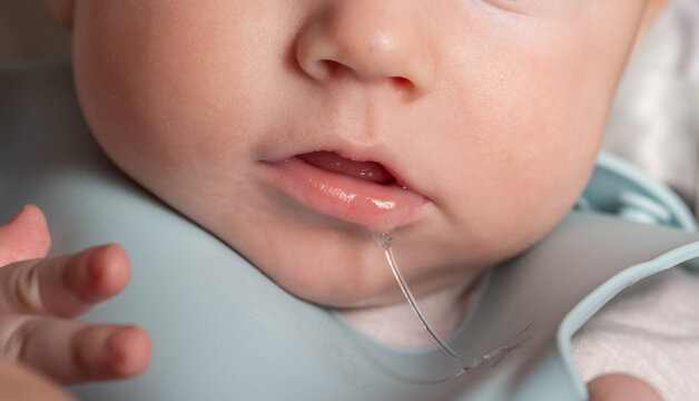 profuse salivation in infants from the mouth. The process of formation and eruption of teeth, close-up