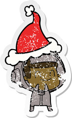happy distressed sticker cartoon of a astronaut wearing santa hat