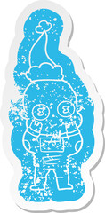 cartoon distressed sticker of a weird bald spaceman wearing santa hat