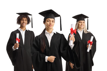 Group of happy graduate students in gowns holding diplomas