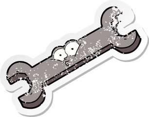 distressed sticker of a cartoon spanner