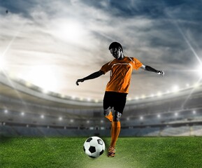 Obraz na płótnie Canvas Soccer scene with player in uniform kicking the ball