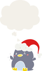 cartoon penguin wearing christmas hat and thought bubble in retro style