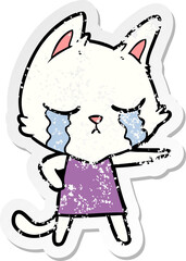 distressed sticker of a crying cartoon cat in dress pointing