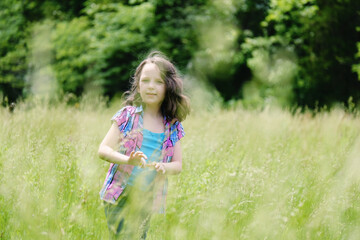 Innocence and happiness of youth with girl in green Ohio meadow during summer.