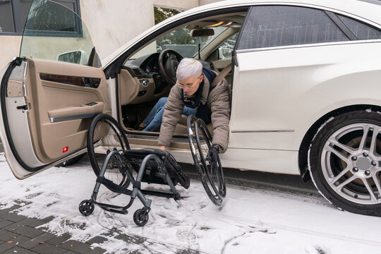Woman With Disability Putting Wheelchair In The Car