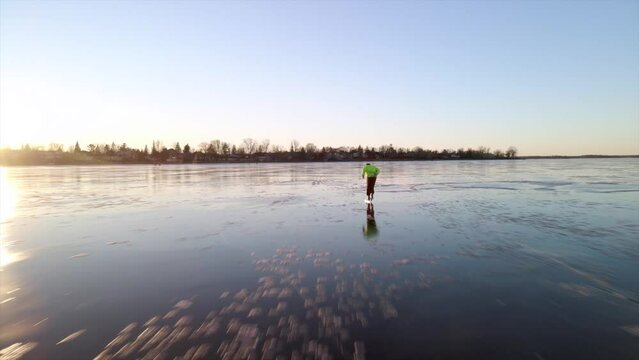 A person skating on a frozen river in winter