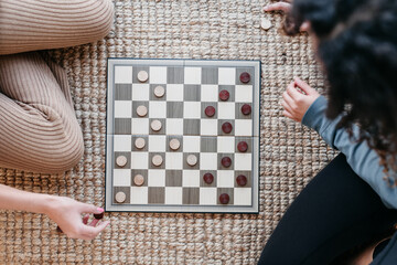 Sisters playing checkers