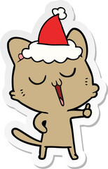 sticker cartoon of a cat singing wearing santa hat