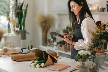 Florist Using Tablet At Flower Shop