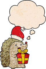 cartoon hedgehog wearing christmas hat and thought bubble in grunge texture pattern style