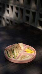 kids meal set, club sandwich with eggs fruits and vegetables, carrot tomato and cord, on food grade plate for kid, children or toddler, top view