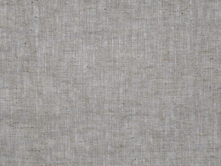 The texture detail of woven linen fabric material is shown in a closeup view.