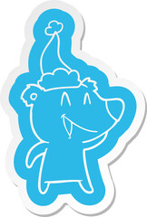 laughing bear cartoon  sticker of a wearing santa hat