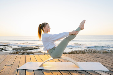 young girl goes in for sports on the beach 
